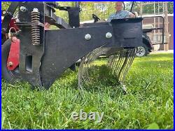 Swinging Tool Bar and Rake with tall Leaf Pushers mounts on a zero turn mower